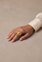 Molten square signet ring in gold worn on the hand